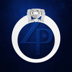 A silver ring with a round-cut diamond set in a circular white bezel, centered on a textured dark blue background with a large embossed blue 'ZP' logo.