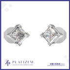 A pair of diamond stud earrings shown on a white background with a blue border. The earrings feature princess-cut diamonds in a four-prong silver setting.