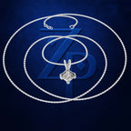 A silver-toned chain necklace with a geometric diamond pendant, arranged in concentric circles over a dark blue textured background with a large stylized 'ZD' logo.