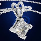 A silver-toned pendant necklace with a large clear rectangular gemstone in a prong setting, suspended from a matching chain against a dark blue background.