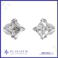 A pair of platinum stud earrings with large clear princess-cut diamonds, displayed on a white background with a blue border. The brand name 'PLATIZEM' is visible at the bottom.