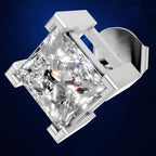 A radiant-cut diamond ring set in a polished silver-toned metal prong setting, shown at an angle against a dark blue textured background.