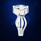 A sculptural white diamond ring with a highly polished, geometric band and a brilliant-cut center stone, set against a dark textured blue background.