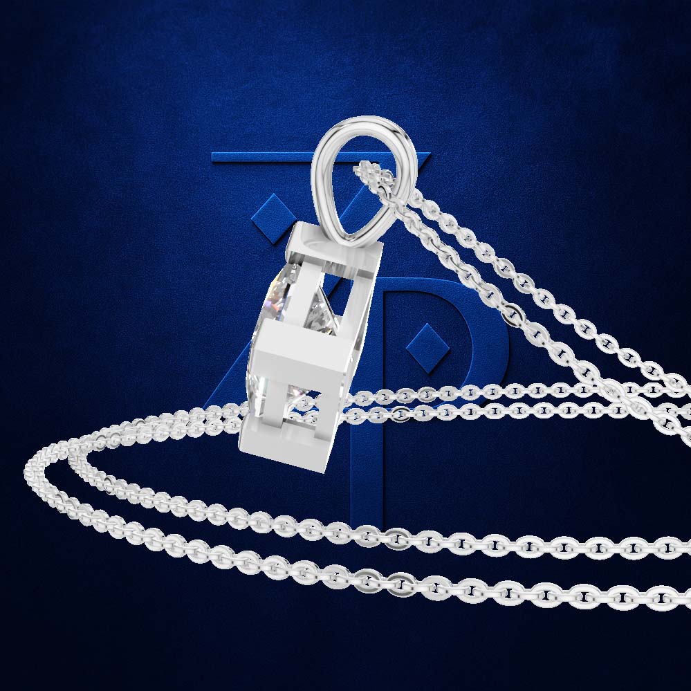 A silver-toned pendant necklace with a geometric, shield-like clasp and a clear faceted stone, shown on a dark blue textured background with a large stylized blue letter behind it.