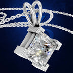 A silver-toned necklace with a princess-cut diamond pendant, shown against a dark blue textured background.