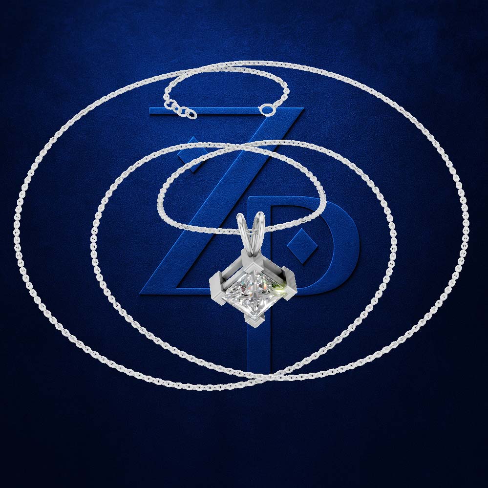 A silver-toned necklace with a geometric pendant featuring a clear gemstone, displayed on a textured dark blue background with a large stylized 'ZD' logo behind it.