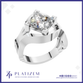 A silver-plated ring featuring a large princess-cut clear gemstone in a square bezel setting, displayed on a white background with a blue border and the brand name 'PLATIZEM' at the bottom.