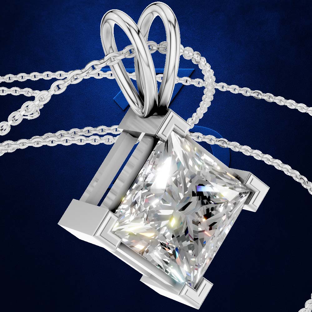 A silver-toned diamond pendant necklace featuring a princess-cut clear diamond in a four-prong setting with a heart-shaped bail, shown on a dark blue textured background.