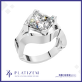A silver-plated square princess-cut diamond ring by Platzem, featuring a split-band design and a brilliant center stone, shown on a white background with a blue border.