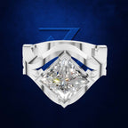 A silver-toned ring featuring a large, brilliant-cut clear gemstone in a diamond shape, set against a textured dark blue background with a subtle blue geometric logo behind it.