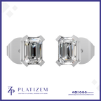 A pair of emerald-cut diamond stud earrings in a silver-toned setting, displayed on a white background with a blue border and the Platizem brand logo at the bottom.