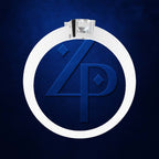 A silver-toned ring with a clear gemstone and a large white oval band featuring a blue embossed monogram logo, set against a dark blue textured background.