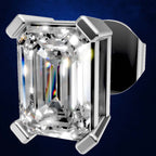 An emerald-cut diamond ring set in a polished silver-toned metal prong setting, shown against a dark blue gradient background.