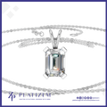 A silver-tone necklace with a large rectangular emerald-cut clear gemstone pendant, displayed on a white background with a branded logo banner at the bottom.