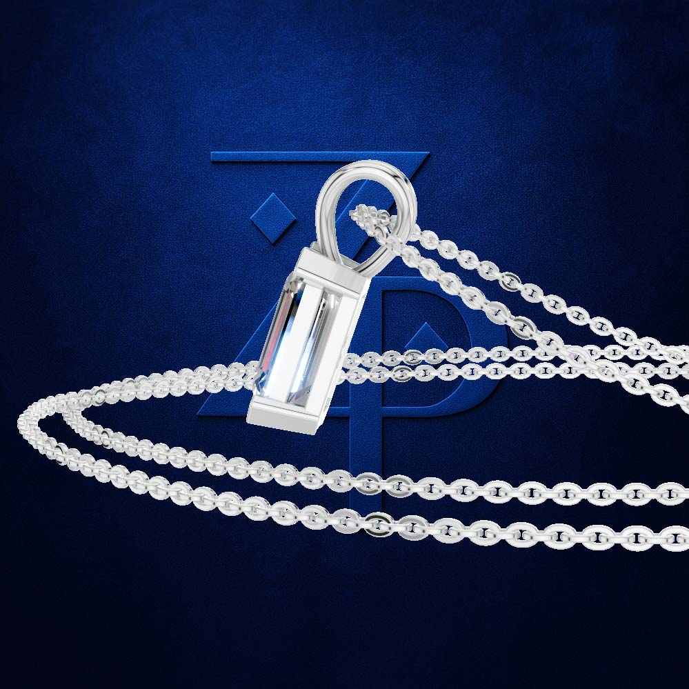 A silver-toned pendant necklace featuring a rectangular clear crystal pendant on a matching chain, displayed against a textured dark blue background with a subtle logo.