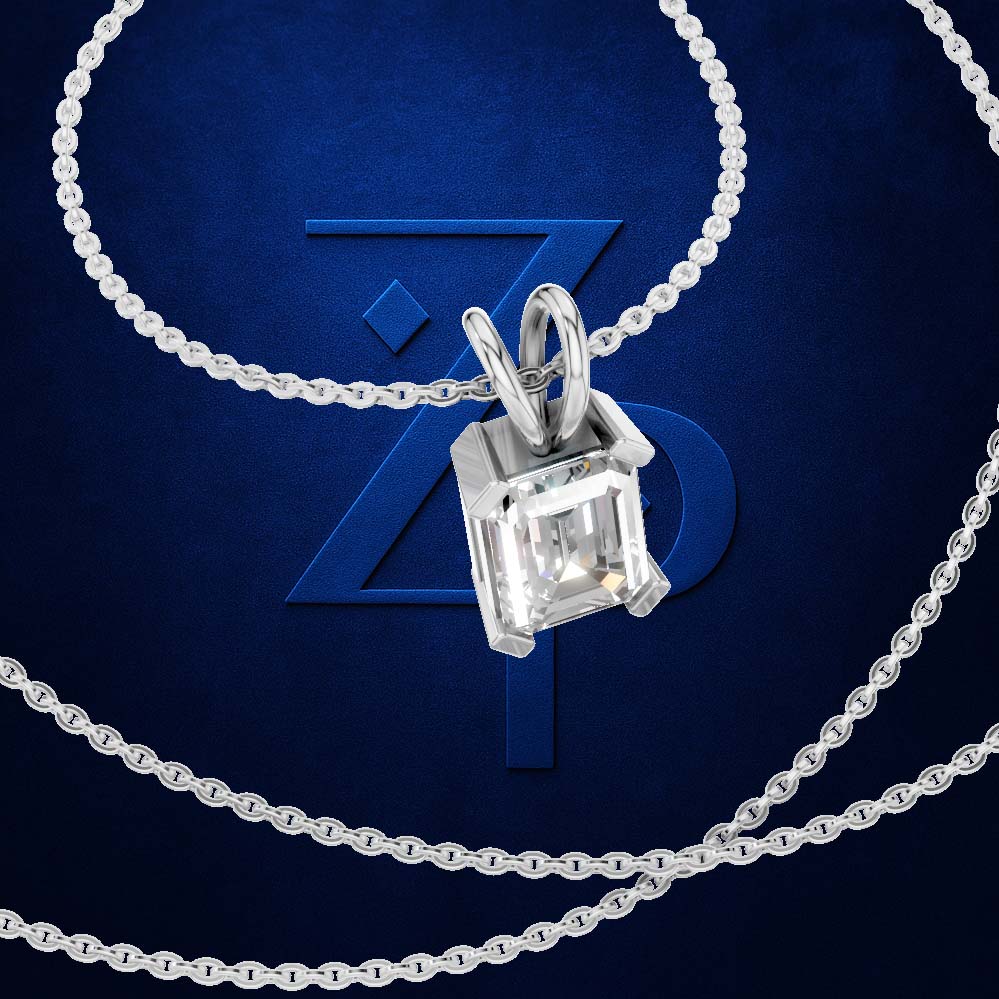 A silver-toned necklace with a rectangular clear gemstone pendant, shown on a dark blue background with a large stylized 'Z' logo behind it.