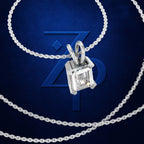 A silver-toned necklace with a rectangular clear gemstone pendant, shown on a dark blue background with a large stylized 'Z' logo behind it.
