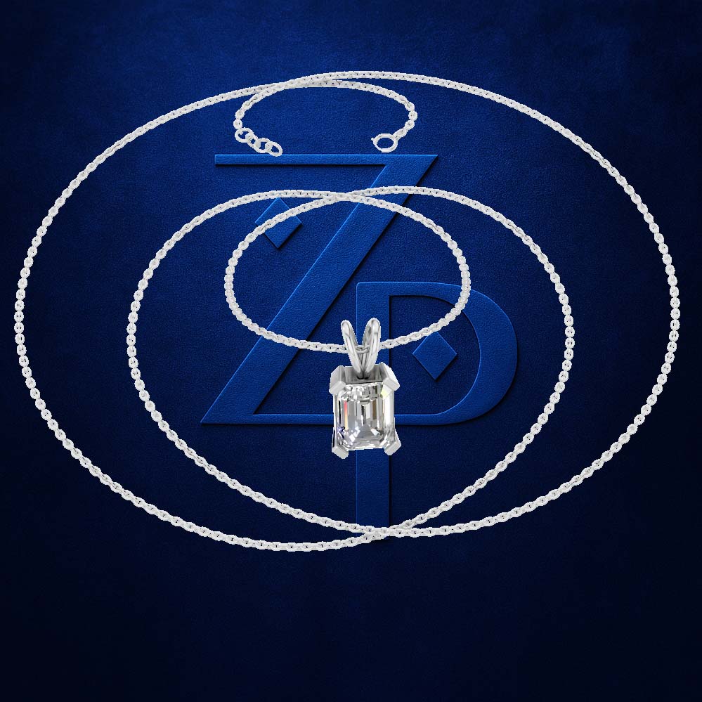 A silver-toned necklace with a rectangular baguette-cut clear gemstone pendant, displayed against a textured dark blue background with a large stylized 'ZD' logo.