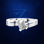 An emerald-cut diamond ring on a polished silver-toned multi-band ring, set against a dark textured blue background with a stylized blue number 7 graphic.