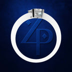 A silver ring with a large clear gemstone, featuring a circular white inlay and a blue monogram design with the letters 'Z' and 'P' on a textured dark blue background.