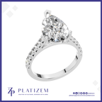 A pear-cut diamond solitaire ring in a silver-colored setting, shown on a white background with a blue border and the Platizem brand logo at the bottom.