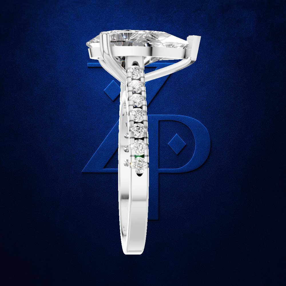 A white gold or platinum solitaire engagement ring featuring a large round brilliant-cut center stone and a channel-set row of smaller round stones on the shank, shown against a dark blue textured background with a stylized blue 'ZP' logo.