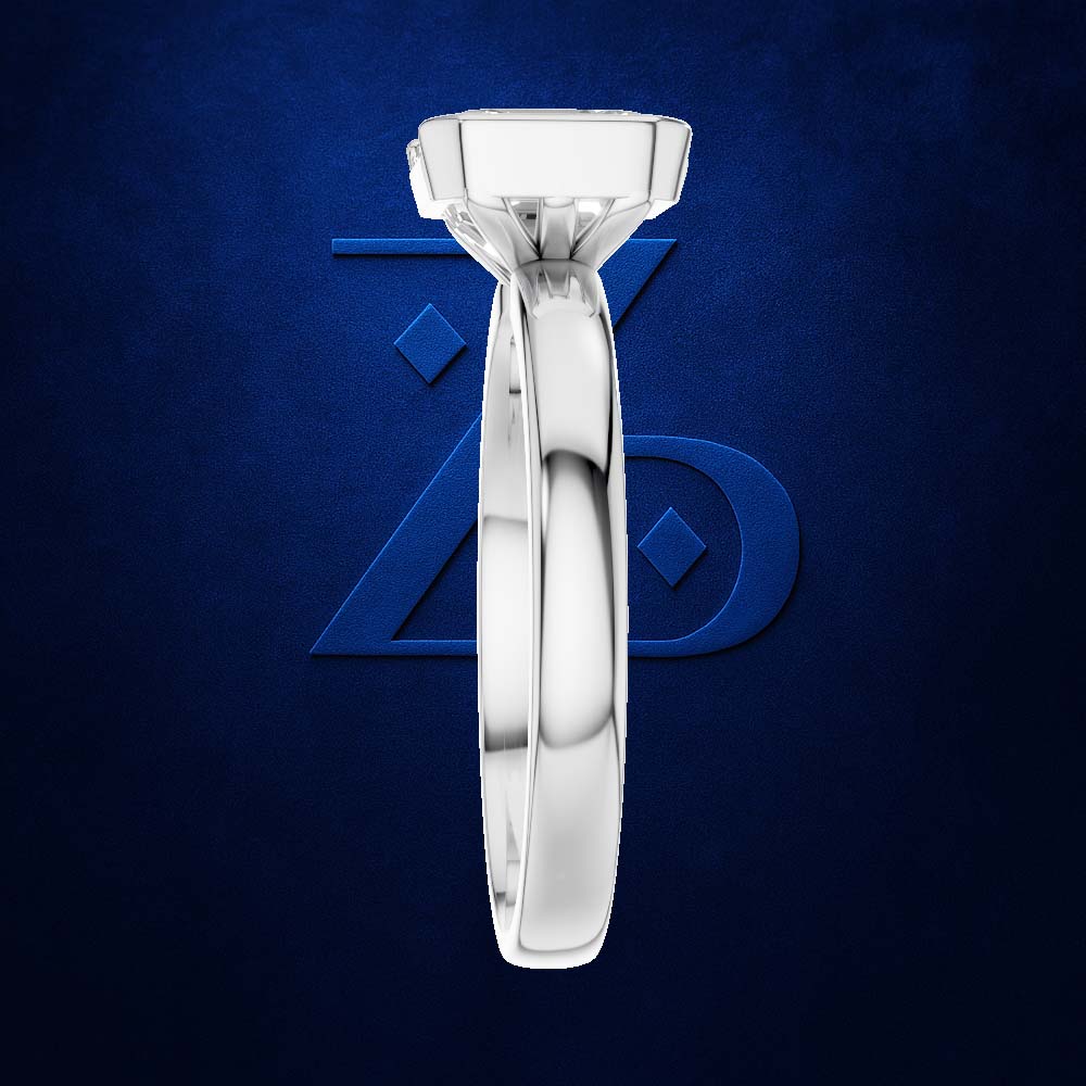 A polished silver-toned diamond engagement ring set in a high-profile round bezel, displayed vertically against a textured dark blue background with a subtle blue geometric logo.