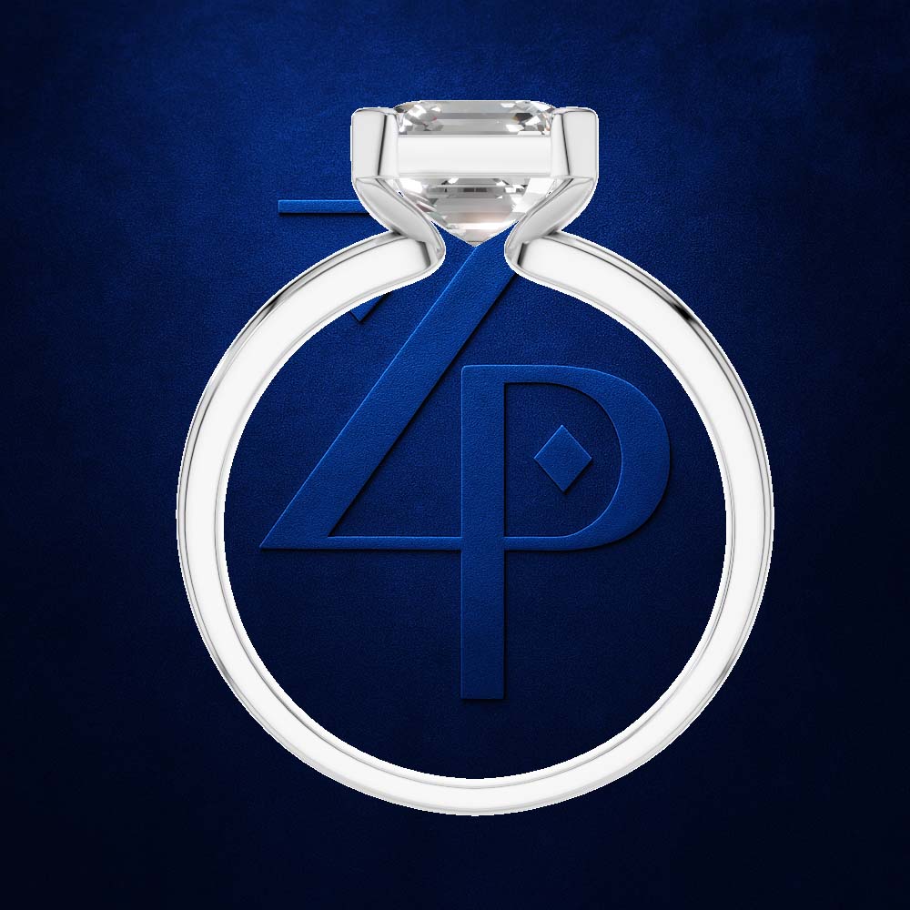 A silver-toned ring with a clear gemstone, centered on a textured dark blue background. The ring features a large oval-cut clear stone in a four-prong setting, with the band forming a circular shape.
