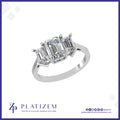 Three Stone Ring Pairing a Statement Emerald Cut with Matching Sides