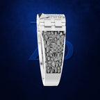 A white gold or platinum ring featuring a textured, organic gray inlay resembling scales or leaves, set against a dark blue background with a subtle blue geometric logo.