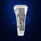 A white gold or platinum ring with a central channel filled with small gray stones, shown on a dark blue textured background with a faint blue geometric logo behind it.