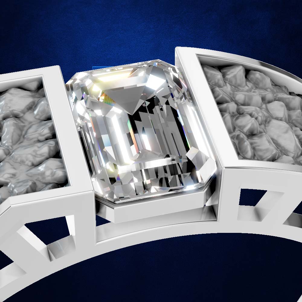 A close-up of a white metal ring setting featuring a large, brilliant-cut clear center stone, with textured gray side stones set in a geometric band against a dark blue background.