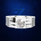 A white gold or platinum men's ring featuring a large round brilliant-cut center stone in a square bezel, flanked by channel-set smaller stones and textured side panels, shown against a dark blue textured background with a blue geometric logo.