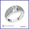 A silver-toned ring with a textured, flower-like pavé setting on the band and a central channel of baguette-cut clear stones, shown on a white background with the Platizem brand logo at the bottom.