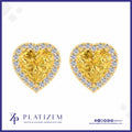 A pair of heart-shaped yellow diamond stud earrings with diamond halo borders, displayed on a white background with the brand logo 'PLATIZEM' at the bottom.