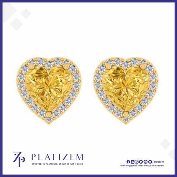 A pair of heart-shaped yellow diamond stud earrings with diamond halo borders, displayed on a white background with the brand logo 'PLATIZEM' at the bottom.